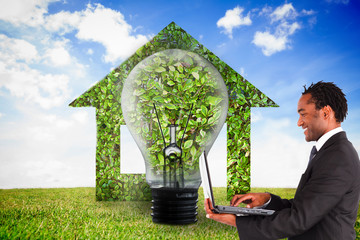 Poster - Composite image of businessman working on laptop