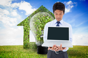Poster - Composite image of businessman showing a laptop