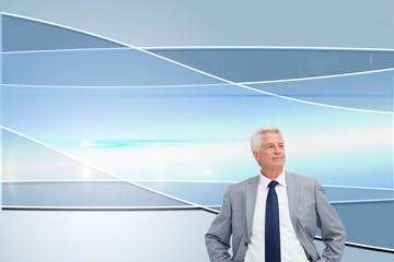Poster - Composite image of man in a suit with his hands on his hips