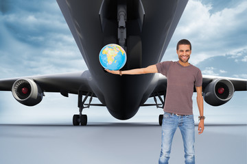Poster - Composite image of handsome man holding out a globe