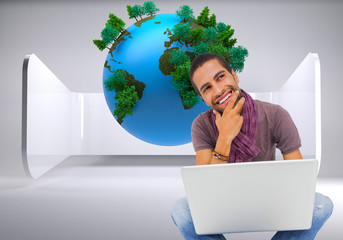 Poster - Composite image of thinking man sitting on floor using laptop an