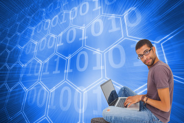 Poster - Composite image of man wearing glasses sitting on floor using la