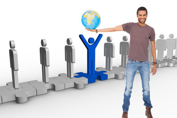 Poster - Composite image of handsome man holding out a globe