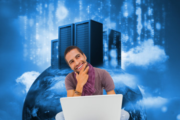Poster - Composite image of thinking man sitting on floor using laptop an