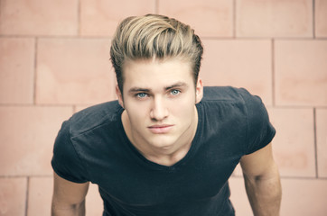 attractive blond young man shot from above, looking up