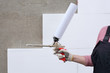 Worker hold polyurethane expanding foam glue gun applicator