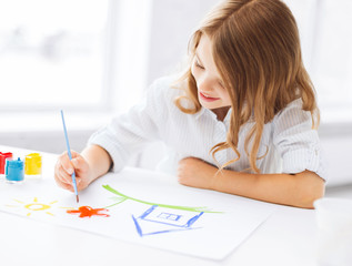 little girl painting picture