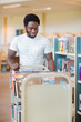 © Tyler Olson - Librarian With Trolley Of Books In Library