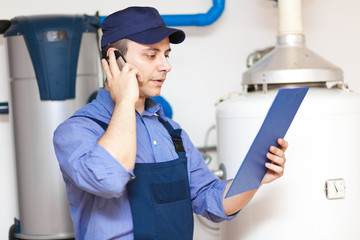 Wall Mural - Plumber talking at the phone