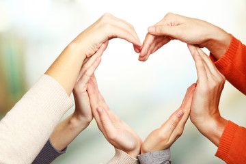 Wall Mural - Human hands in heart shape on bright background