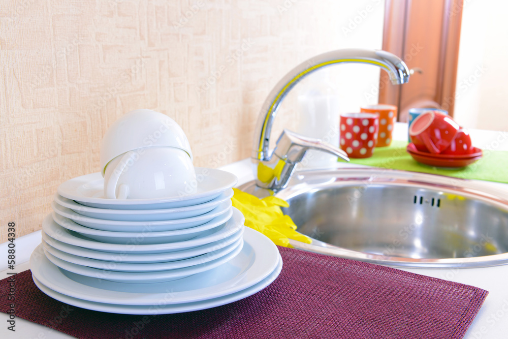 Dishes drying near  metal sink