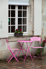 Empty pink table in the cafe during the rain