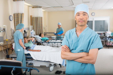 Wall Mural - Confident Male Nurse Standing In Ward