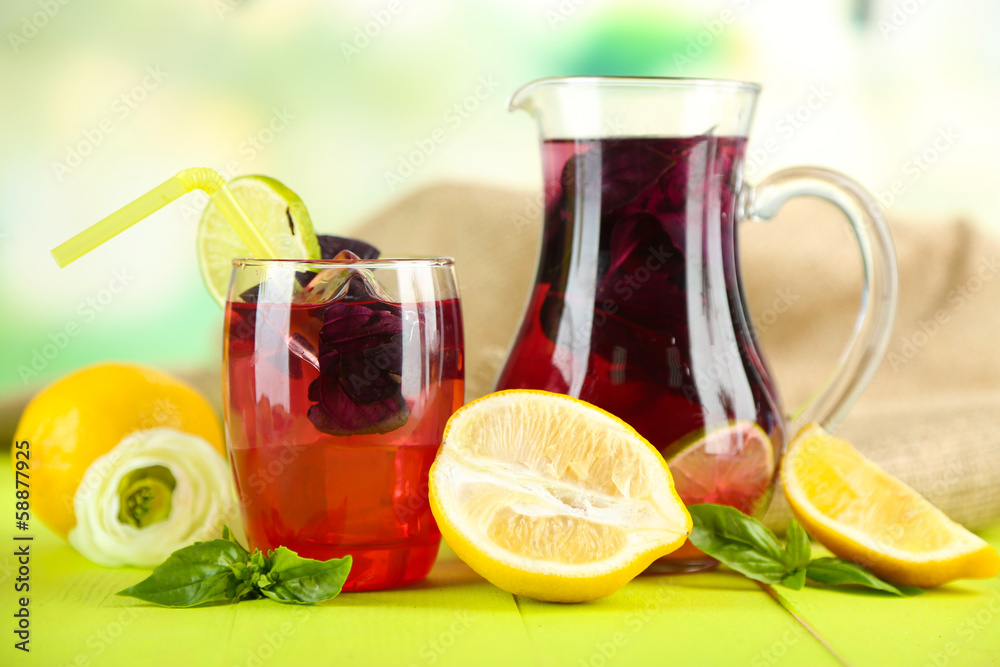 Red basil lemonade in jug and glass,