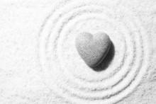 Grey Zen Stone In Shape Of Heart, On Sand Background