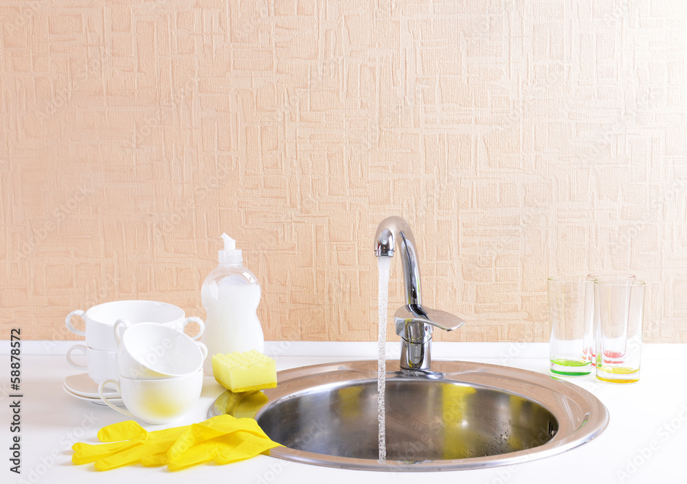 Dishes drying near  metal sink