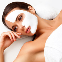 Wall Mural - Young Woman at Spa Salon With Cosmetic Mask on Face.