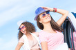 © adam121 - Two attractive young women wearing sunglasses