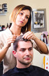 © Lsantilli - Happy female hairstylist setting client's hair