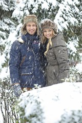 Wall Mural - Happy couple embracing in winter forest