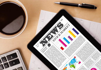 Wall Mural - tablet pc shows news on screen with a cup of coffee on a desk