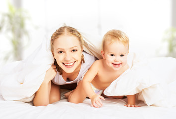 Poster - happy family mother and baby under blankets in bed