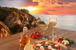Italian pizza and glasses of wine against Calabria coast, Italy
