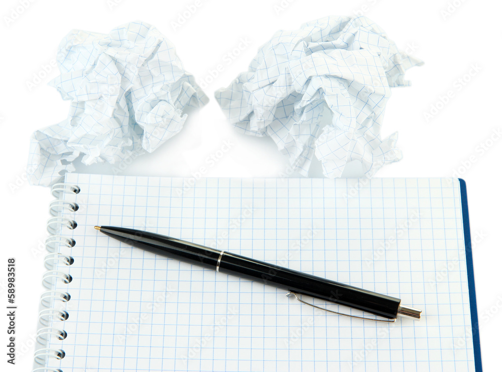 Crumpled paper balls with notebook and pen isolated on white