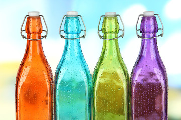 Wall Mural - Colorful bottles on bright background
