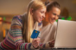 © Alliance - Closeup on happy two girlfriends making online shopping