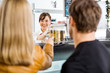 © Tyler Olson - Saleswoman Attending Customers At Butcher's Shop