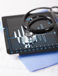 tablet pc, stethoscope and electrocardiogram