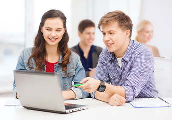 Wall Mural - students with laptop and notebooks at school