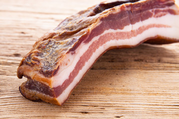 Bacon on old wooden board