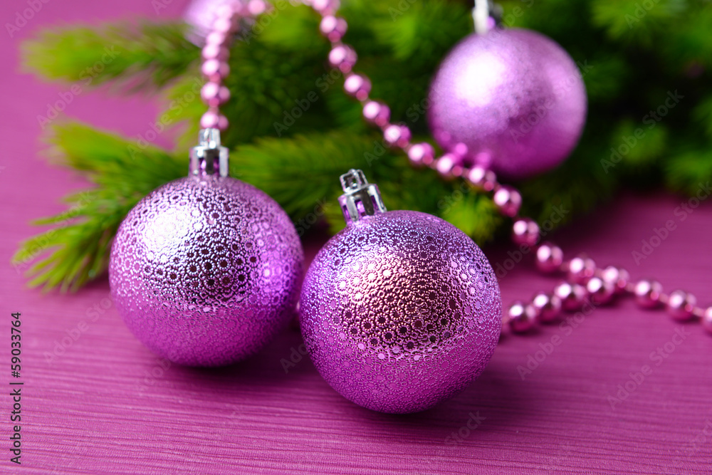 Christmas balls on fir tree, on color background