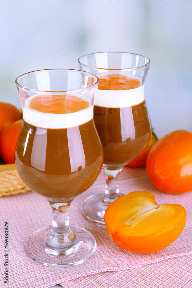 Dessert of chocolate and persimmon on table on light background