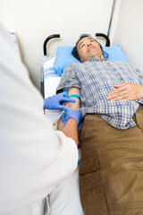 Doctor Drawing Blood From Patient's Arm