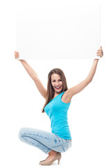 Wall Mural - Attractive young woman with blank sign