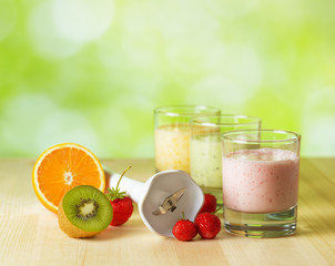 Wall Mural - Fruit smoothie on wooden table on narural background