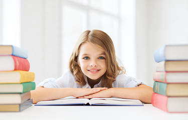 Poster - smiling little student girl with many books