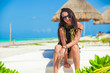 © travnikovstudio - Young sexy woman sitting on a boat in white sandy beach