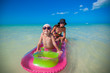 Little girl with young mother on an air mattress in the sea