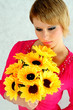 The beautiful blonde with a bouquet of sunflowers