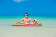 © travnikovstudio - Young father with cute daughter on an air mattress in the sea