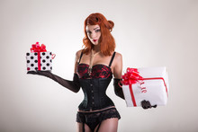 Portrait Of Pretty Redhead Pin-up Girl Holding Gift Boxes
