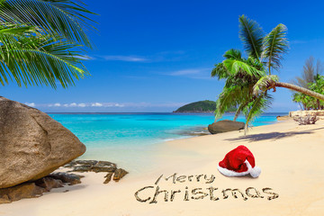 Wall Mural - Merry Christmas with santa hat on the tropical beach