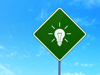 Business concept: Light Bulb on road sign background