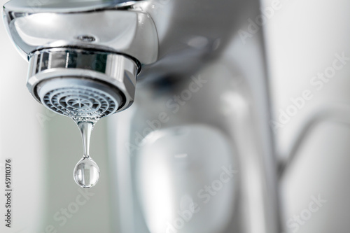 Fotografia  Tap closeup with dreaping waterdrop. Water leaking, economy conc