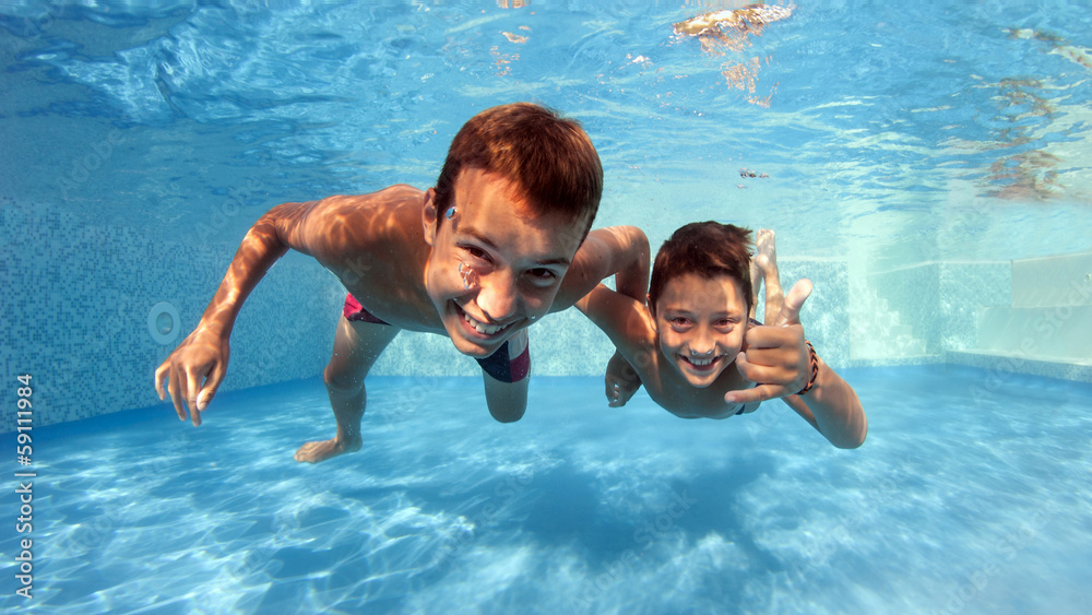 Underwater brothers portrait in swimming pool. Stock Photo | Adobe Stock