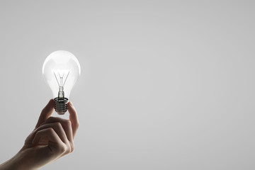 Poster - hand holding lightbulb